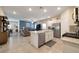 Open-concept layout with a spacious kitchen island overlooking a comfortable living area with tile flooring at 4505 Meline Ave, North Las Vegas, NV 89084