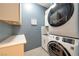 Functional laundry room featuring modern appliances, a sink, and ample counter space at 4505 Meline Ave, North Las Vegas, NV 89084