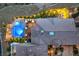 Bird's-eye view of a luxury home featuring a pool, patio area, and unique roof design in a desert landscape at 47 Strada Principale, Henderson, NV 89011