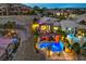 Overhead shot of a luxurious property with a beautiful pool and spa, featuring covered patios and landscaping at 47 Strada Principale, Henderson, NV 89011