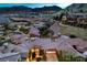 Expansive aerial view showcasing a residential area with stunning mountain views and meticulously landscaped properties at 47 Strada Principale, Henderson, NV 89011