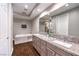 Bathroom with double vanity, granite countertop, framed mirror, and a separate tub with tile surround at 47 Strada Principale, Henderson, NV 89011