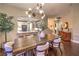 Bright dining area with breakfast bar features a rustic wooden table and modern lighting fixture at 47 Strada Principale, Henderson, NV 89011