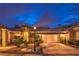 Inviting home exterior featuring a well-maintained garden and a cozy, illuminated facade at dusk at 47 Strada Principale, Henderson, NV 89011