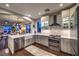 Well-lit kitchen with stainless steel appliances, an island sink, and an open floor plan at 47 Strada Principale, Henderson, NV 89011
