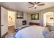 Cozy bedroom featuring a large bed, a fireplace, and a sitting area, with a view to the bathroom at 47 Strada Principale, Henderson, NV 89011