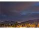 Nighttime view of city lights and mountains from a serene residential area at 47 Strada Principale, Henderson, NV 89011