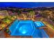 Gorgeous backyard pool and spa area with stunning city and mountain views at twilight at 47 Strada Principale, Henderson, NV 89011