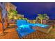Inviting pool and spa with stone accents, lush greenery, and umbrella-covered seating areas provide a peaceful retreat at 47 Strada Principale, Henderson, NV 89011