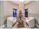 A sitting room featuring two cozy chairs, two windows and a decorative light fixture at 47 Strada Principale, Henderson, NV 89011