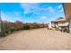 Spacious backyard featuring gravel landscaping with a covered patio and mature trees at 4981 Alondra Dr, Las Vegas, NV 89118