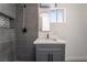 Stylish bathroom featuring modern vanity, mirror, and walk-in shower with gray tiling at 4981 Alondra Dr, Las Vegas, NV 89118
