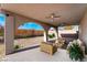 Inviting covered patio area with comfortable seating and a cozy fire pit at 4981 Alondra Dr, Las Vegas, NV 89118