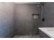 Contemporary walk-in shower features gray subway tile and unique mosaic tile niche at 4981 Alondra Dr, Las Vegas, NV 89118
