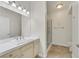 Well-lit bathroom featuring a vanity with tile countertop and a glass-enclosed shower at 5250 S Rainbow Blvd # 1144, Las Vegas, NV 89118