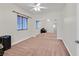 Bright bedroom with neutral carpet, a ceiling fan, and closet with mirrored doors at 5250 S Rainbow Blvd # 1144, Las Vegas, NV 89118