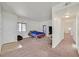 Bright bedroom featuring neutral decor, carpeting, a double bed, and easy access to the hallway at 5250 S Rainbow Blvd # 1144, Las Vegas, NV 89118