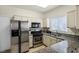 Modern kitchen featuring stainless steel appliances, granite countertops, and ample cabinet space at 5250 S Rainbow Blvd # 1144, Las Vegas, NV 89118