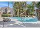 Inviting pool area with lounge chairs, mature palm trees, and waterfall feature at 5250 S Rainbow Blvd # 1144, Las Vegas, NV 89118