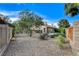 This backyard is landscaped with mature trees, gravel, and a patio area at 5541 Port Barrington Way, Las Vegas, NV 89130