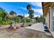 Landscaped backyard features lush greenery, potted plants, and a cozy patio area at 5541 Port Barrington Way, Las Vegas, NV 89130