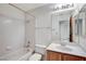 Bathroom featuring tiled shower-tub, large mirror, vanity, and ample lighting at 5541 Port Barrington Way, Las Vegas, NV 89130