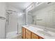 Bright bathroom featuring a dual sink vanity, shower with glass doors, and ample lighting at 5541 Port Barrington Way, Las Vegas, NV 89130