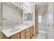 Bathroom featuring a double sink vanity, large mirror, and separate tub and shower at 5541 Port Barrington Way, Las Vegas, NV 89130