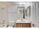 Tiled bathroom featuring a vanity, shower with glass doors, and ample lighting at 5541 Port Barrington Way, Las Vegas, NV 89130