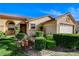 Single-story home showcases mature landscaping, a two-car garage, and a charming front patio area at 5541 Port Barrington Way, Las Vegas, NV 89130