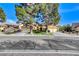 Charming single-story home featuring mature trees, a well-maintained lawn, and a two-car garage at 5541 Port Barrington Way, Las Vegas, NV 89130