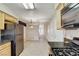 The kitchen features stainless steel appliances and leads into an adjacent dining area with tile flooring at 5541 Port Barrington Way, Las Vegas, NV 89130
