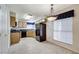 Kitchen with wood cabinets, black appliances, and a tile floor at 5541 Port Barrington Way, Las Vegas, NV 89130