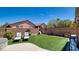 Spacious backyard featuring artificial grass, lounge chairs, and a well-maintained privacy fence at 5820 Amber Station Ave, Las Vegas, NV 89131