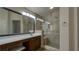 This bathroom features wood cabinets, a makeup counter, a walk-in shower, and a modern sink at 5820 Amber Station Ave, Las Vegas, NV 89131