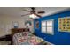 A secondary bedroom features a ceiling fan, window shutters, and personalized wall décor at 5820 Amber Station Ave, Las Vegas, NV 89131