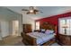 This primary bedroom boasts a ceiling fan, rich wood furniture, and a decorative accent wall at 5820 Amber Station Ave, Las Vegas, NV 89131