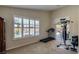 This room includes a treadmill, free weights, window shutters, and access to the back patio at 5820 Amber Station Ave, Las Vegas, NV 89131