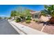 Charming single-story home with desert landscaping, mature trees, and well-maintained lawn at 5820 Amber Station Ave, Las Vegas, NV 89131