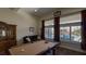 This game room has a pool table, plush sofa, backyard view, and ample space for entertaining at 5820 Amber Station Ave, Las Vegas, NV 89131