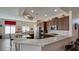 Spacious open-concept kitchen featuring marble countertops, stainless appliances, and modern finishes at 5820 Amber Station Ave, Las Vegas, NV 89131