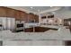Modern kitchen with granite countertops, stainless steel appliances, and dark wood cabinetry at 5820 Amber Station Ave, Las Vegas, NV 89131