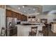 Well-lit kitchen with a breakfast bar, stainless steel appliances, and elegant dark wood cabinets at 5820 Amber Station Ave, Las Vegas, NV 89131