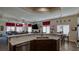 Open kitchen seamlessly flows into the living area, featuring a breakfast bar and ample counter space at 5820 Amber Station Ave, Las Vegas, NV 89131