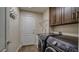 Laundry room with front loading machines, sink, and overhead shelving at 5820 Amber Station Ave, Las Vegas, NV 89131