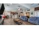 Bright, open living room with wood-look tile flooring, a kitchen island, and comfortable seating at 5820 Amber Station Ave, Las Vegas, NV 89131