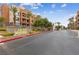 Entrance to Park Avenue Condominiums, featuring lush landscaping and mature palm trees at 59 E Agate Ave # 306, Las Vegas, NV 89123