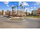 Community entrance featuring a decorative fountain surrounded by flower beds and green lawns at 59 E Agate Ave # 306, Las Vegas, NV 89123