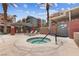 Community hot tub area surrounded by palm trees and multi-story condominium buildings at 59 E Agate Ave # 306, Las Vegas, NV 89123