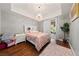 Comfortable main bedroom featuring wood floors, chandelier, and balcony access at 59 E Agate Ave # 306, Las Vegas, NV 89123
